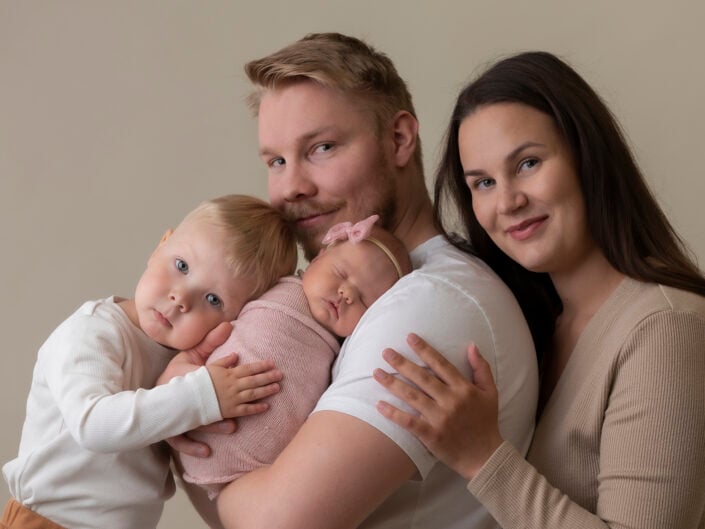 Vanhemmat halaamassa ja pitämässä lapset sylissä