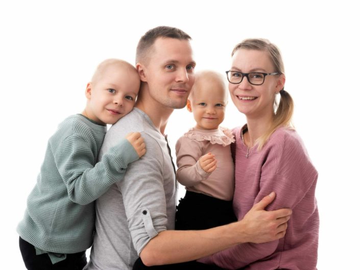 Smiley family posing with kids for family photo